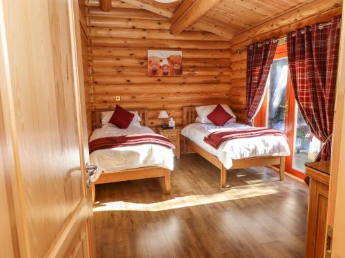 Postel nebo postele na pokoji v ubytování Rowan Lodge