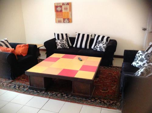 a living room with two couches and a coffee table at Calabash Apartment-Hotel in Kotu
