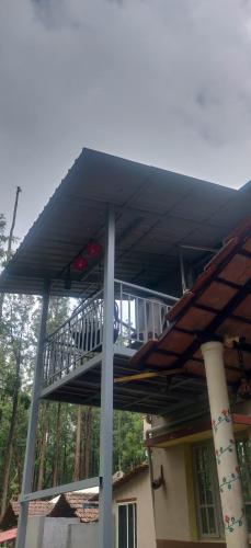 a deck on the side of a house at The Inchara Hill View HomeStay in Chikmagalūr