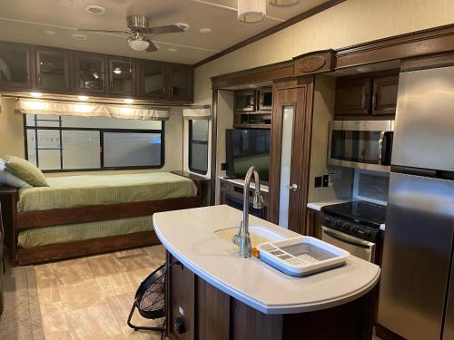 a kitchen in an rv with a sink and refrigerator at Palapa Bajazul in Loreto