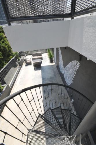 an overhead view of a spiral staircase with chairs and tables at The Nest House in Melaka