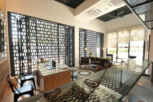 a living room with a glass table and chairs at The Nest House in Melaka