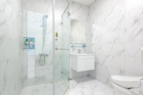 a bathroom with a shower and a toilet and a sink at Revel Villa in Puli