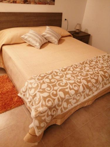 a bed with a white comforter and pillows on it at APPARTAMENTO CORSO VITTORIO EMANUELE in Ortona