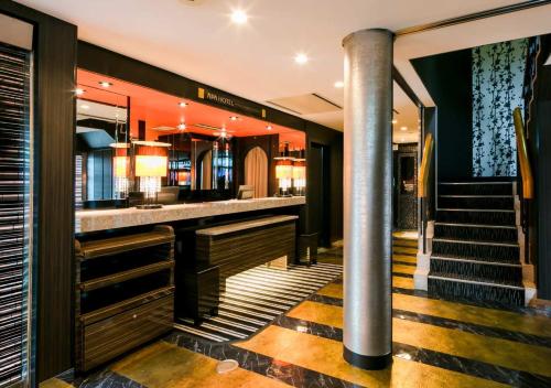 a bar in a building with stairs and a lobby at APA Hotel Nagasaki Ekimae in Nagasaki