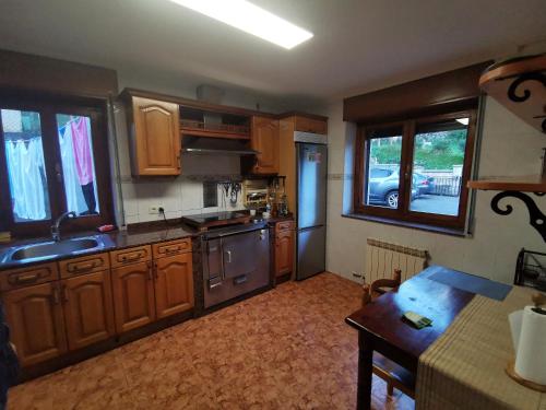 a kitchen with wooden cabinets and a stove top oven at Casa pando 49 in Pando