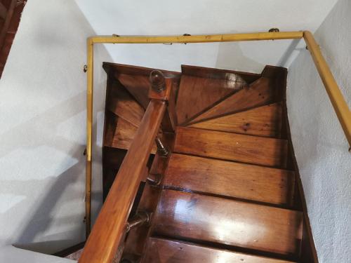 a wooden stairway with a railing on top of it at Casa pando 49 in Pando