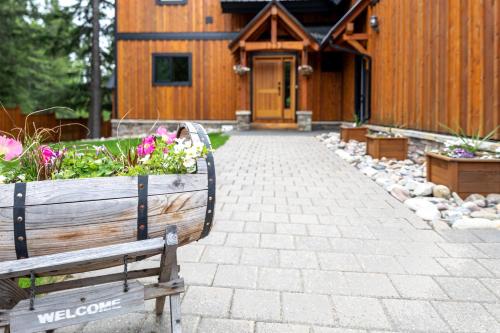 a wooden building with a bench in front of it at Canyon Ridge Lodge in Golden
