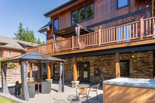a house with a deck and a patio at Canyon Ridge Lodge in Golden