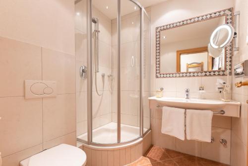 a bathroom with a shower and a sink and a toilet at Alpenschlössl Boutique Appartements & Rooms in Neustift im Stubaital