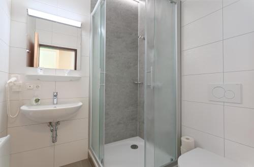 a bathroom with a shower and a sink at Jugendgästehaus Bad Ischl in Bad Ischl