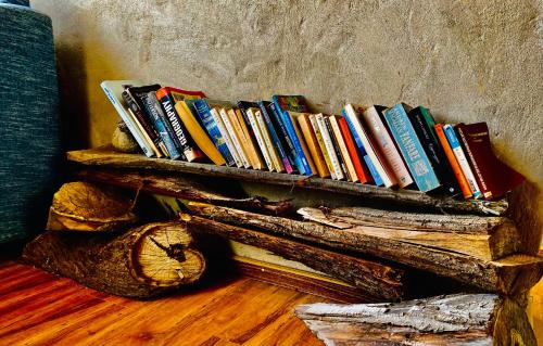 a pile of books sitting on top of a shelf at Old Hunza inn in Hunza Valley