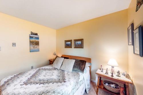 a bedroom with a bed and a table at Summer Daze in Edgartown