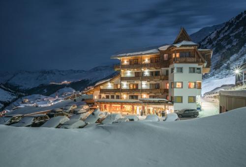 a large building in the snow at night at Schönblick - Gurgl B&B in Obergurgl