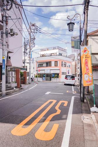 a street with a stop sign on the road at Shinjuku ICE MOUNTAIN GUEST HOUSE in Tokyo