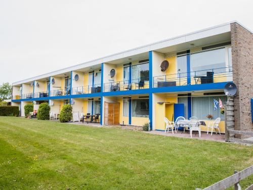 a building with a lawn in front of it at Vakantiehuisje Martina 26 in Vlissingen