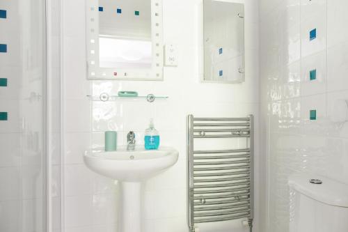 a white bathroom with a sink and a mirror at Walsingham House - Peaceful Elevated - Near Oram's Arbour in Winchester