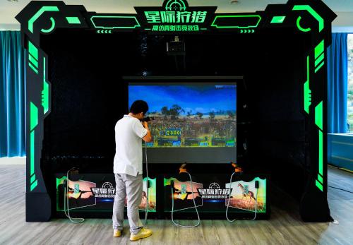 a man standing in front of a video game at Misty Wonderland ,Yangshuo Xingping in Yangshuo