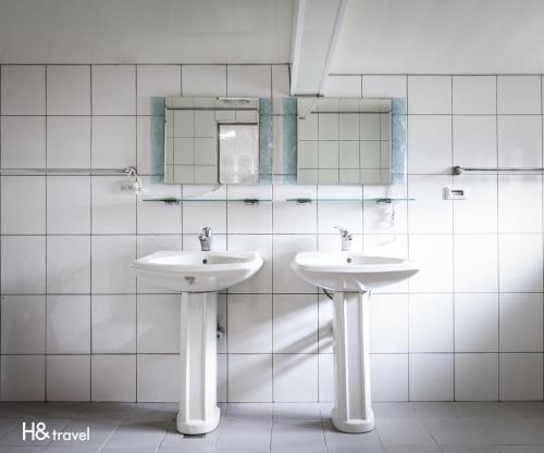 a bathroom with two sinks and a mirror at Alishan Sunrise B&B in Fanlu