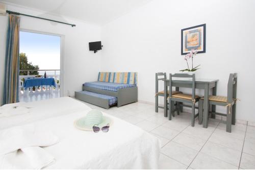 a living room with a bed and a table at Papidakis Studios in Agia Marina Nea Kydonias