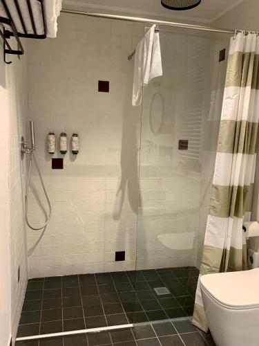 a bathroom with a shower with a shower curtain at Il Poggio di Musignano in Musignano