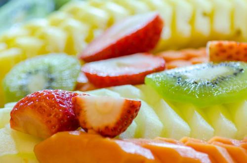 a plate of fruit with strawberries and kiwis and oranges at Rossio Plaza Hotel in Lisbon