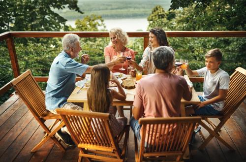 a group of people sitting around a table on a deck at Laguna Platz in Sremski Karlovci