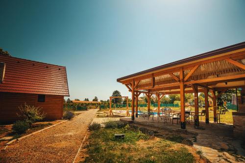 a pavilion with tables and chairs in a field at Laguna Platz in Sremski Karlovci