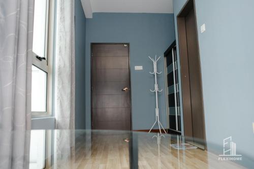 a hallway with blue walls and a door at 10am-6pm, SAME DAY CHECK IN AND CHECK OUT, Work From Home, Shaftsbury-Cyberjaya, Comfy Home by Flexihome-MY in Cyberjaya
