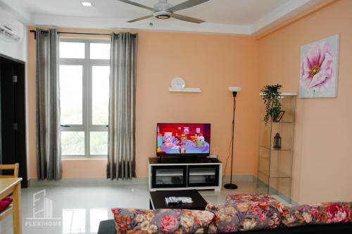 a living room with a couch and a tv at 10am-6pm, SAME DAY CHECK IN AND CHECK OUT, Work From Home, Shaftsbury-Cyberjaya, Comfy Home by Flexihome-MY in Cyberjaya