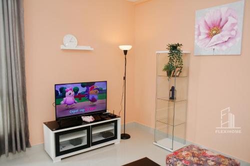 a living room with a tv on a stand at 10am-6pm, SAME DAY CHECK IN AND CHECK OUT, Work From Home, Shaftsbury-Cyberjaya, Comfy Home by Flexihome-MY in Cyberjaya