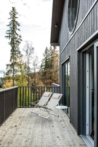 a deck with a lounge chair on the side of a building at Villabranten! Ski In - Ski Out, Bike In - Bike Out in Järvsö