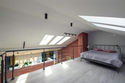 a bedroom with a bed and a brick wall at Sun&Sport Apartament PANORAMA dwupoziomowy i przestronny in Szczyrk