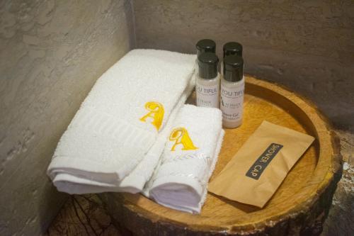 a group of towels on a wooden table at Altrude By The Sea in Candolim