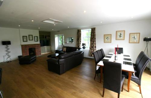 a living room with a couch and a table at Garden House at The Red House Estate in York
