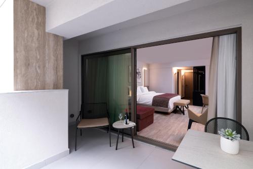 a hotel room with a view of a bedroom at S Hotel Boutique Thessaloniki in Thessaloniki