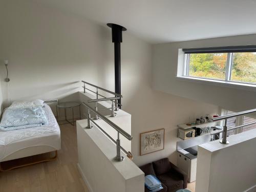 a bedroom with stairs and a bed in it at Nordbornholms Feriecenter in Hasle