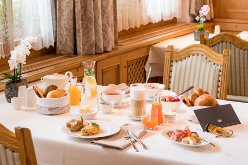 a table with breakfast foods and drinks on it at Das Homann in Samnaun