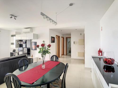 a dining room and kitchen with a table and chairs at Heaven I by LovelyStay in Caniço