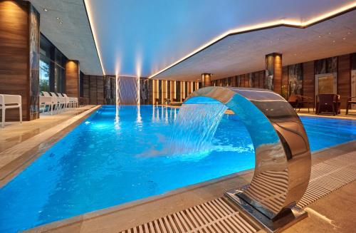 a swimming pool with a waterfall in a hotel at Premier Hotel Odesa in Odesa