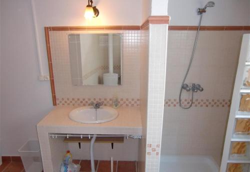 a bathroom with a sink and a mirror and a tub at Townhouse Almunecar Old Town in Almuñécar