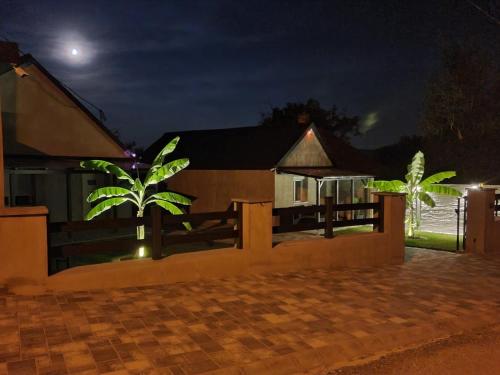 a house with a fence in front of it at night at Sunny Garden Apartment in Bogács