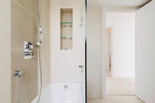 a shower with a glass door in a bathroom at Executive Waterfront Split Penthouse in Woolwich