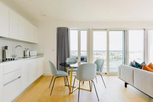 a kitchen and living room with a table and chairs at Executive Waterfront Split Penthouse in Woolwich