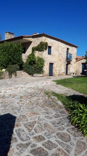 a building with a stone walkway in front of it at Casa dos Castaños in O Grove