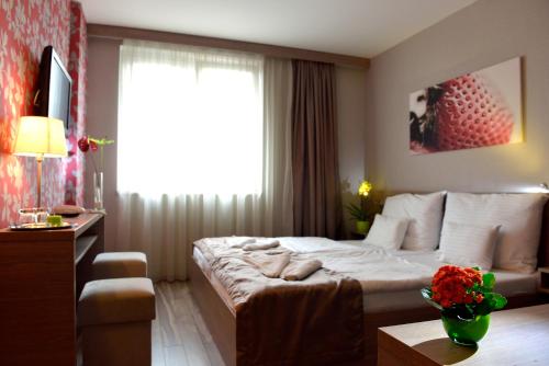 a hotel room with a bed and a window at Vitta Hotel Superior Budapest in Budapest