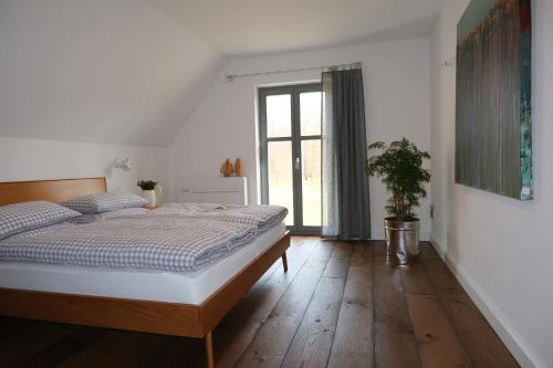 a bedroom with a bed and a large window at HOFSTELLE No. 133 in Burg