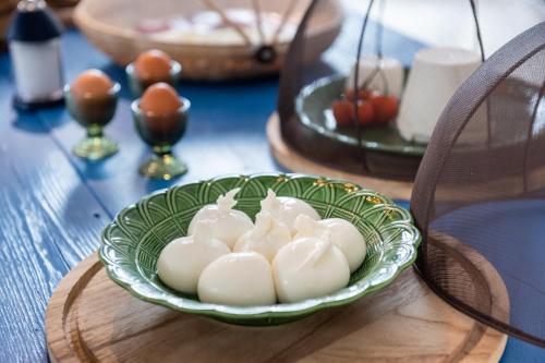 a green bowl of marshmallows on a wooden table at Masseria Borgo San Marco in Fasano