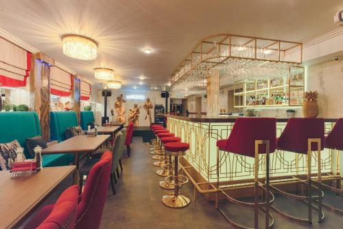 restauracja ze stołami i krzesłami oraz bar w obiekcie Bazilevs Boutique Hotel w Petersburgu