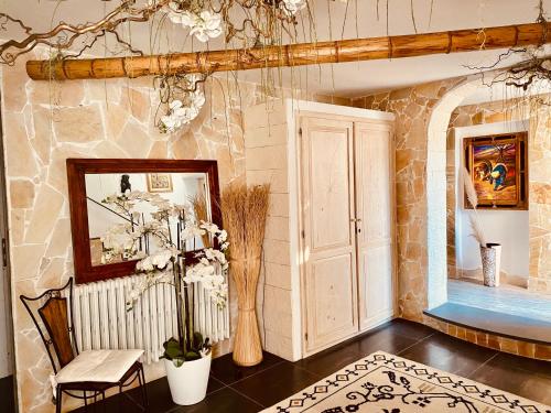 a living room with a table and a wall at ANTICA DIMORA STORICA VILLA DI l ABBIU RELAIS in Sorso